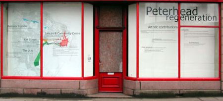 A shop on Kirk Street, Peterhead, that was cleaned up and which had proposals for the area displayed on the windows, using vinyl lettering, by Sans façon, summer 2005. Photograph by Sans façon.