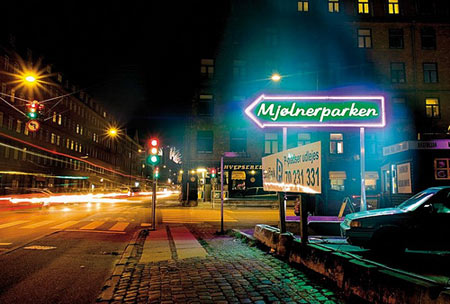 Superflex's controversial  neon sign   'Mjolnerparken' erected directly opposite the residential area of that name. Part of the Sit Down! Project in Mimersgade, Copenhagen 2006. Photo: Kaare Smith.