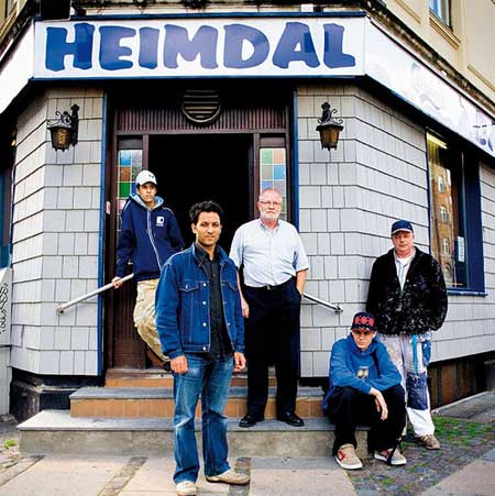 The artist Kenneth A Balfelt initiated a collaborative project to transform the tired facade of Cafe Heimdal, bringing together divided communities. Part of the Sit Down! Project in Mimersgade, Copenhagen 2006. Photo: Kaare Smith.