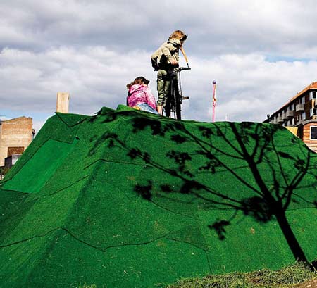 Children interact with Parfyme's temporary hilly landscape, Bakkeland, created as part of the Sit Down! project in Mimersgade, Copenhagen 2006. Photo: Kaare Smith.