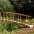 Link to larger image: Footbridge in wood by Keith Rand, 1998.River Parrett Trail, Somerset.