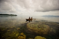 Young children fish over the shallow reefs around Nuakata Island,a marine protected area in Papua New Guinea. © James Morgan